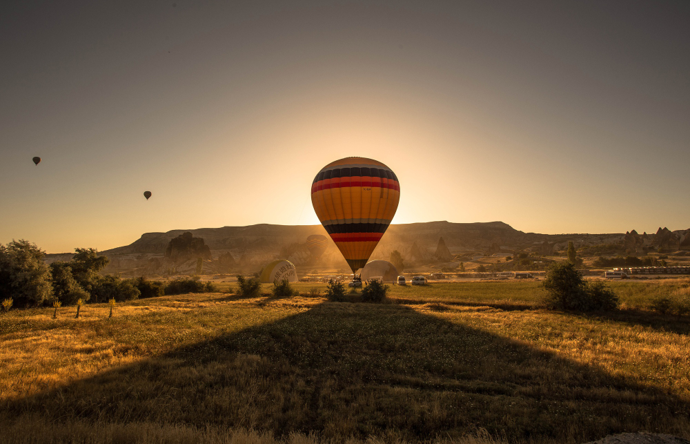 A hot-air balloon at sunrise.